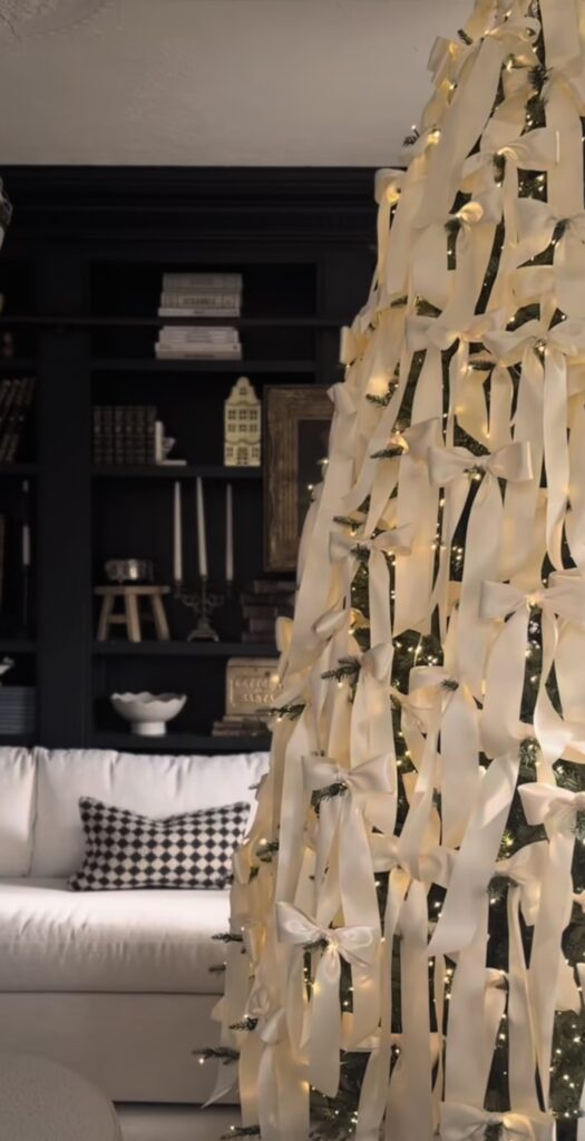 sculptural ribbon tree layered with ivory bows, minimal ornaments, warm micro lights, monochrome ivory modern living room