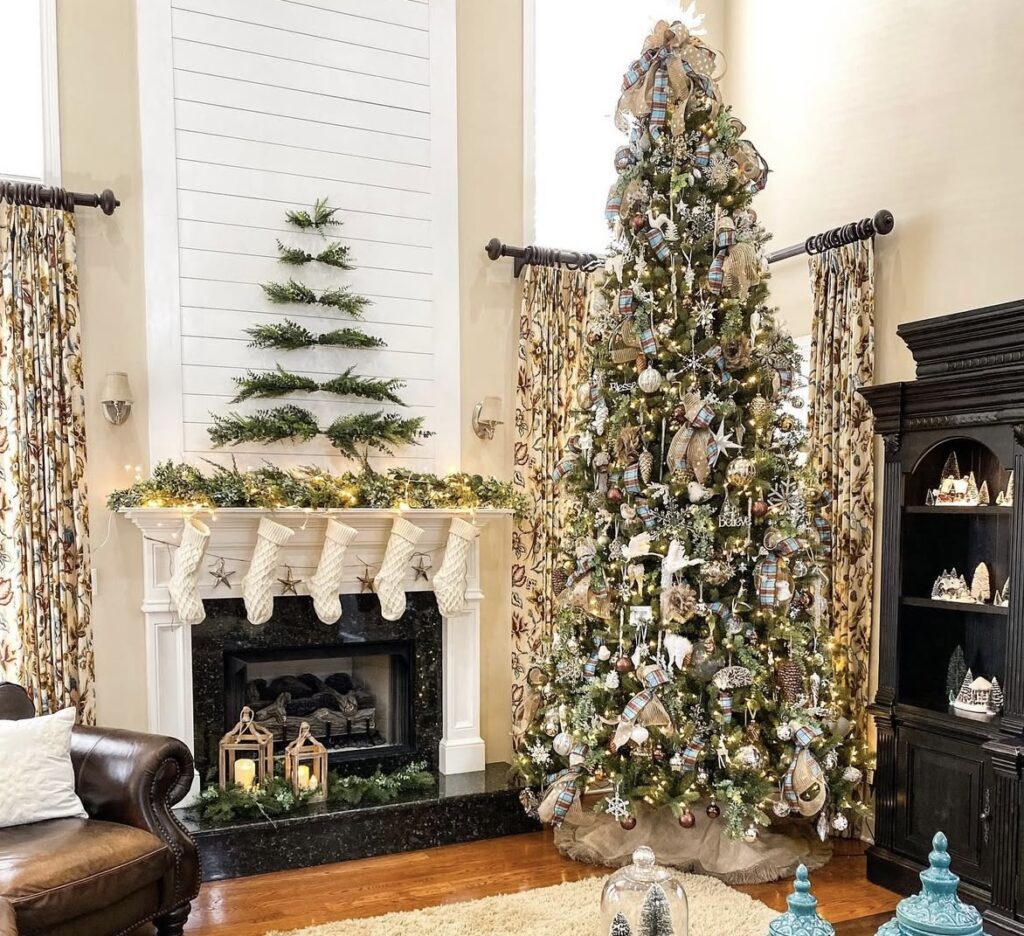 tall living room tree with plaid ribbon, burlap mesh, snowflake ornaments, eucalyptus sprigs, white birds, “Believe” sign