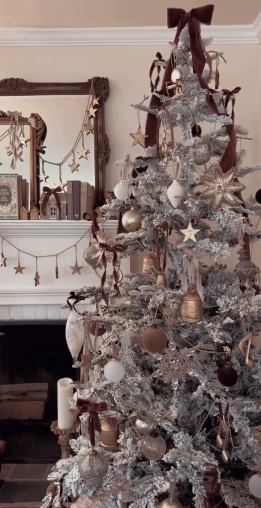 vintage inspired frosted tree with burgundy velvet ribbons, gold stars and bells, pearl garlands