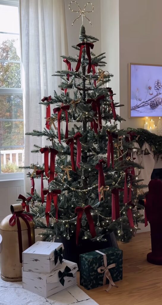 whimsical bow tree with red and taupe bows, crystal icicles, gold bead garland, light-up bow topper, cozy living room