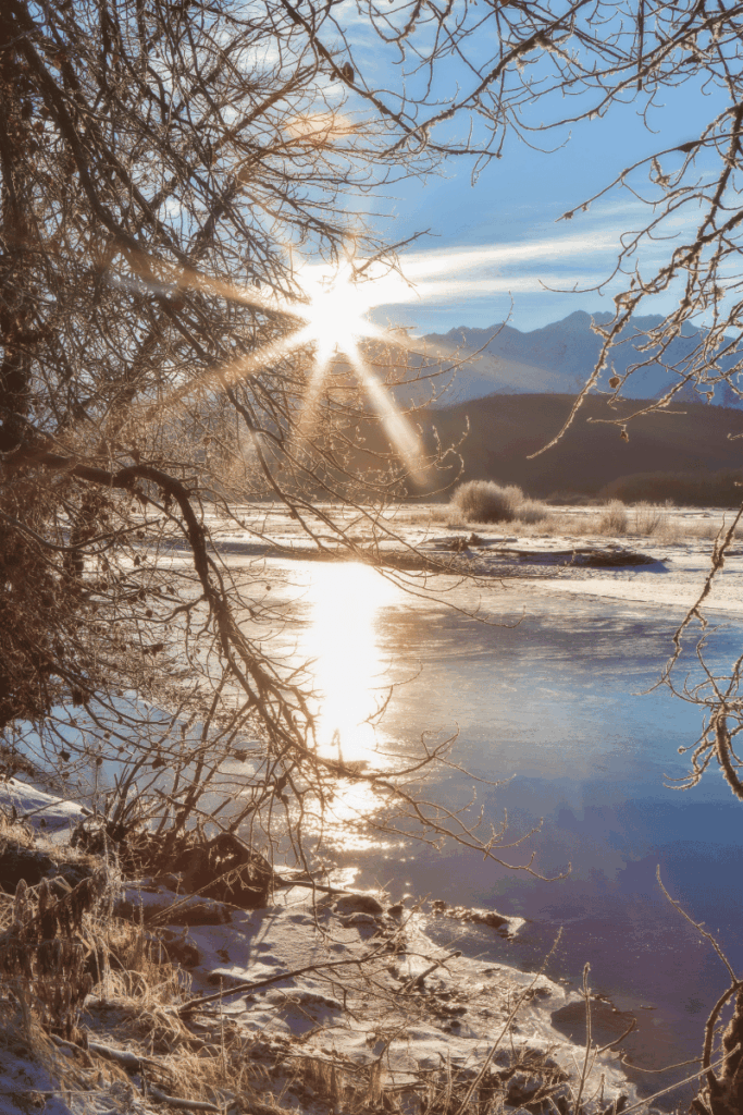 Image of a river in the winter with the sun rising