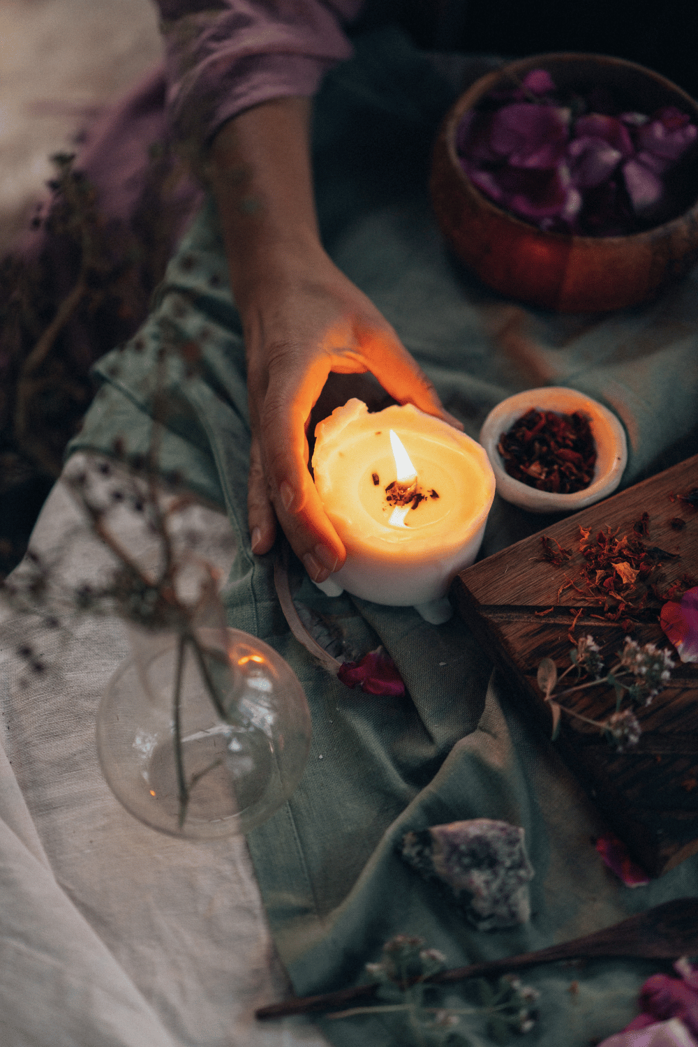 Candle, journal and mug on a wooden table for quiet Winter Solstice reflection.