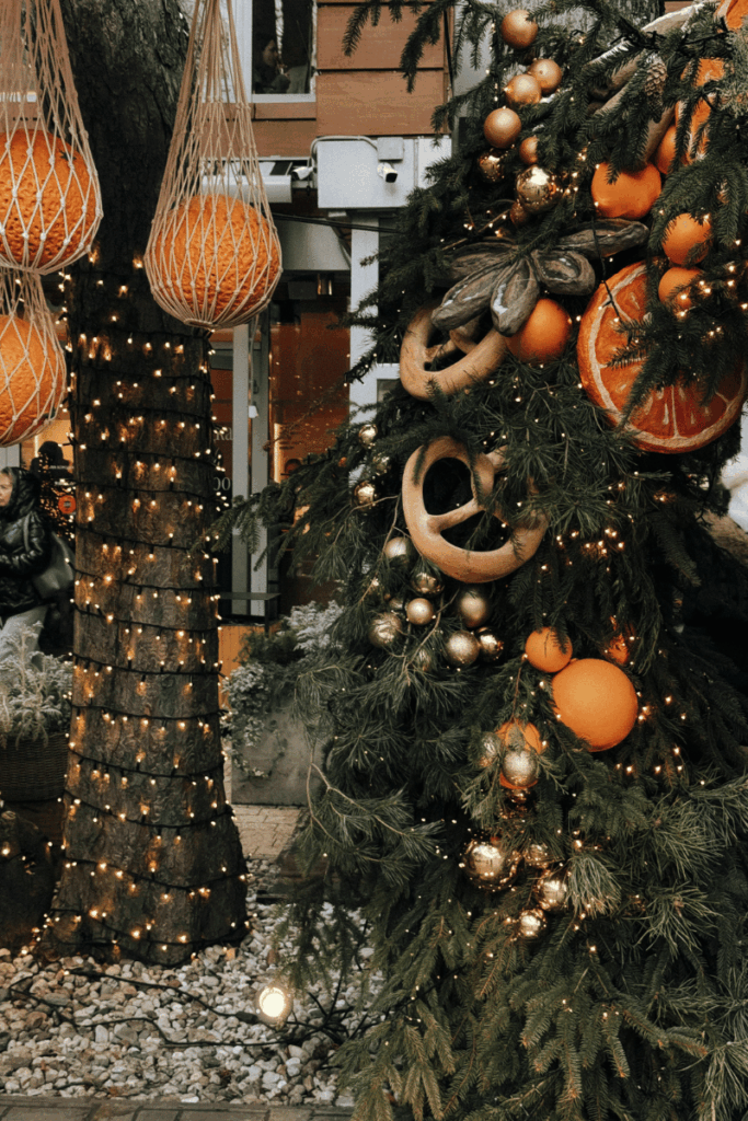 images of yule celebrations with decorated tree with lights, candles and oranges for winter solstice