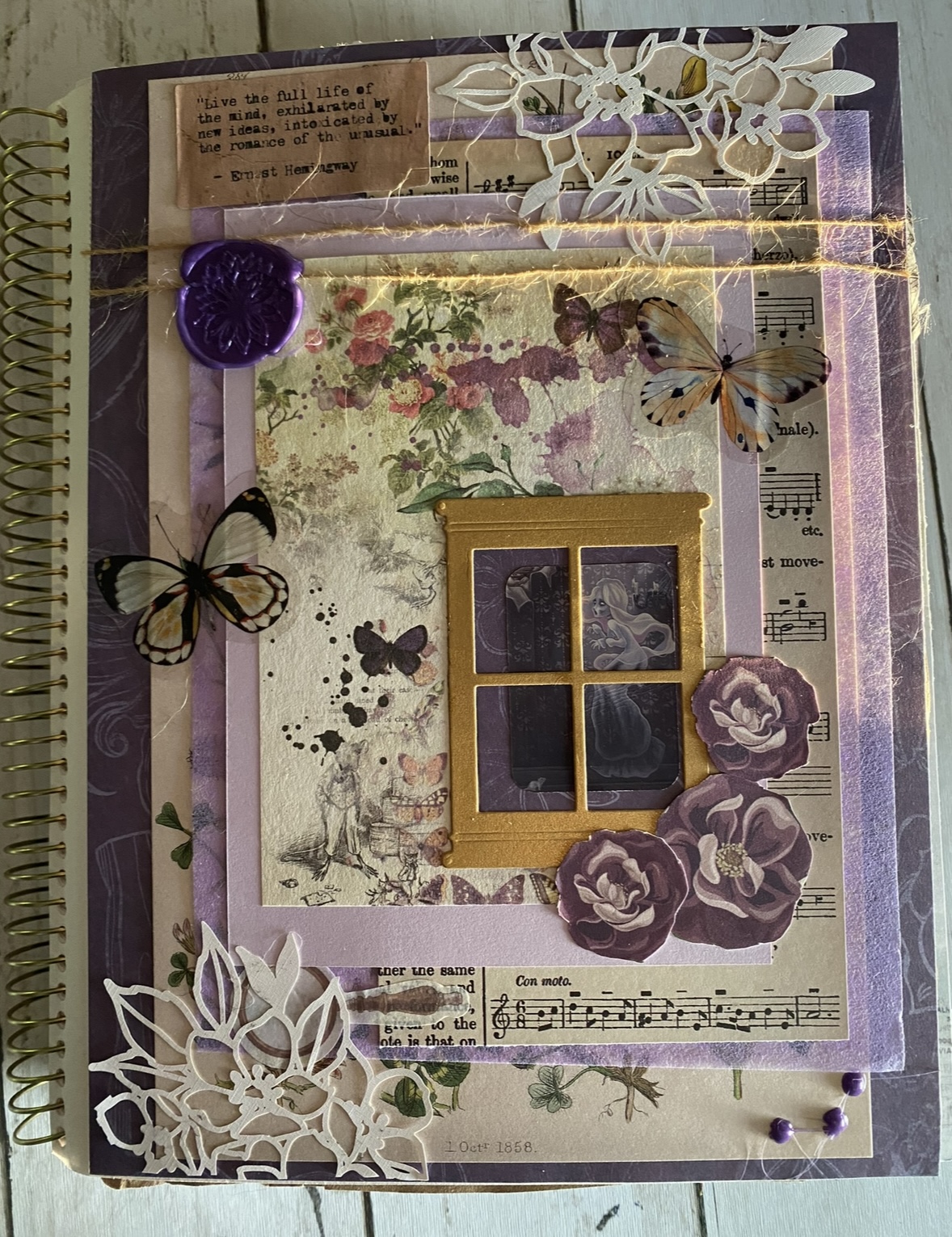 Mayhem Crafters house scene with a subtle ghost in the window, layered die cuts, and stitched title.