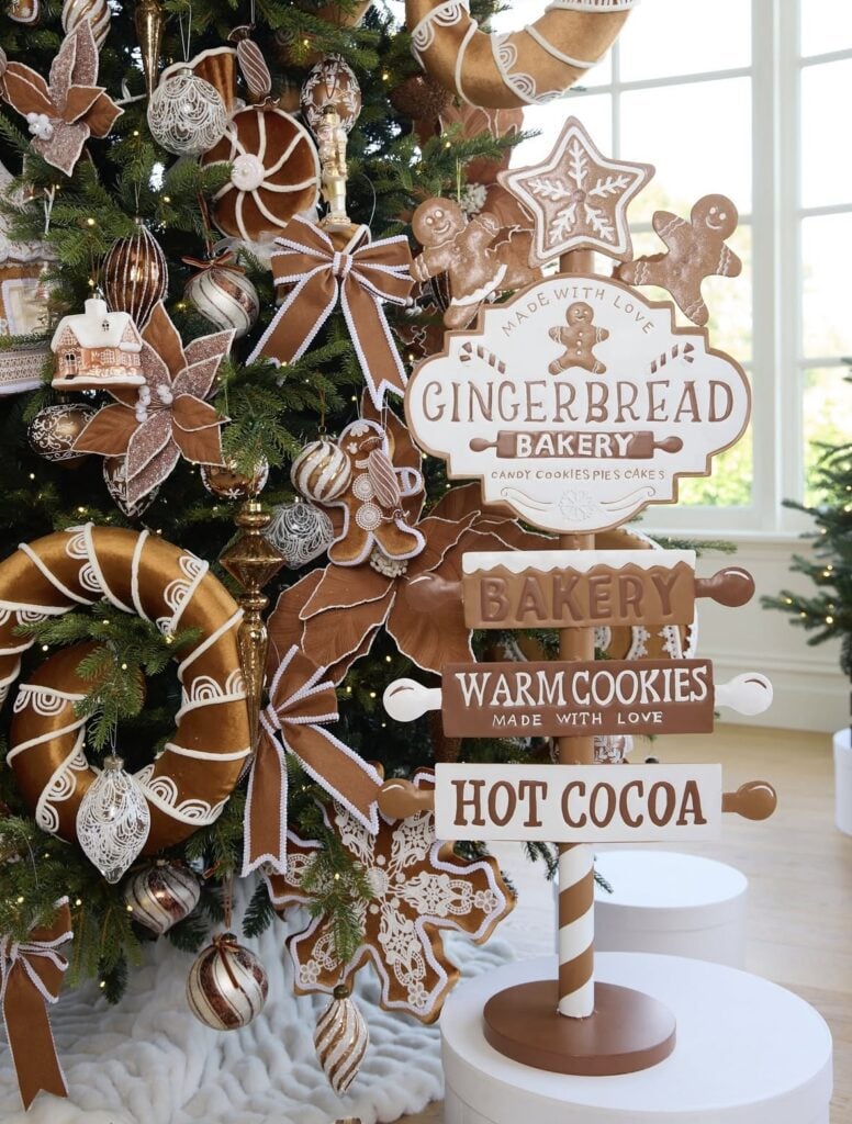 Gingerbread-themed Christmas tree in a cozy living room with a “Gingerbread Street” sign, candy cane accents, and warm white lights.