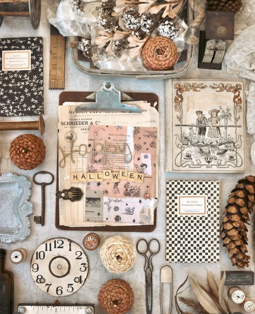 Cozy vintage junk journal spread with tea-stained paper, lace, and stamped Halloween ephemera.