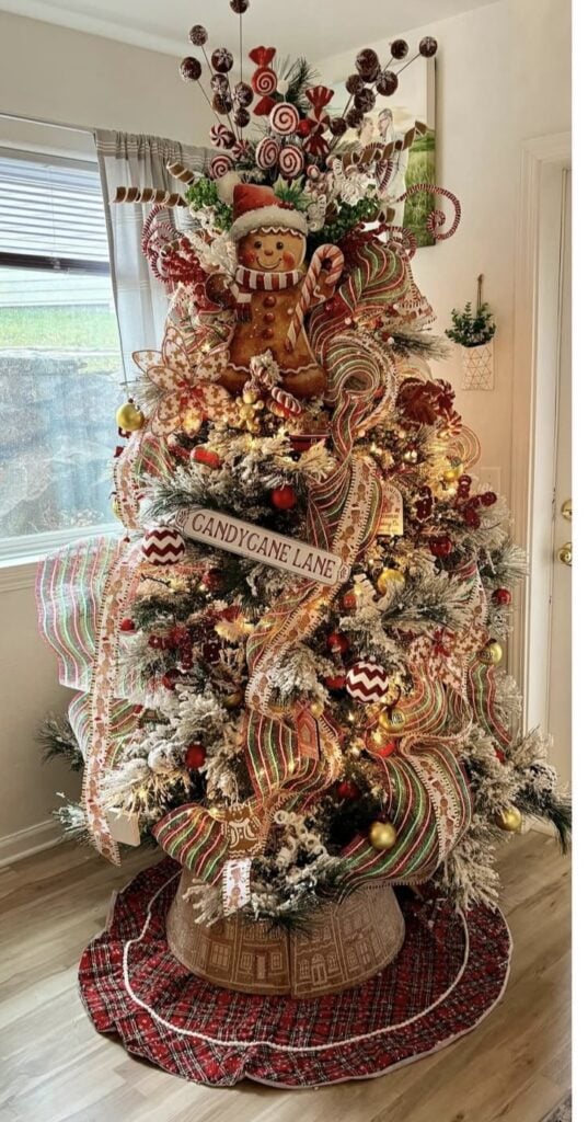 Candy cane lane gingerbread Christmas tree with red and green ribbon, cookie ornaments, and playful candy details.