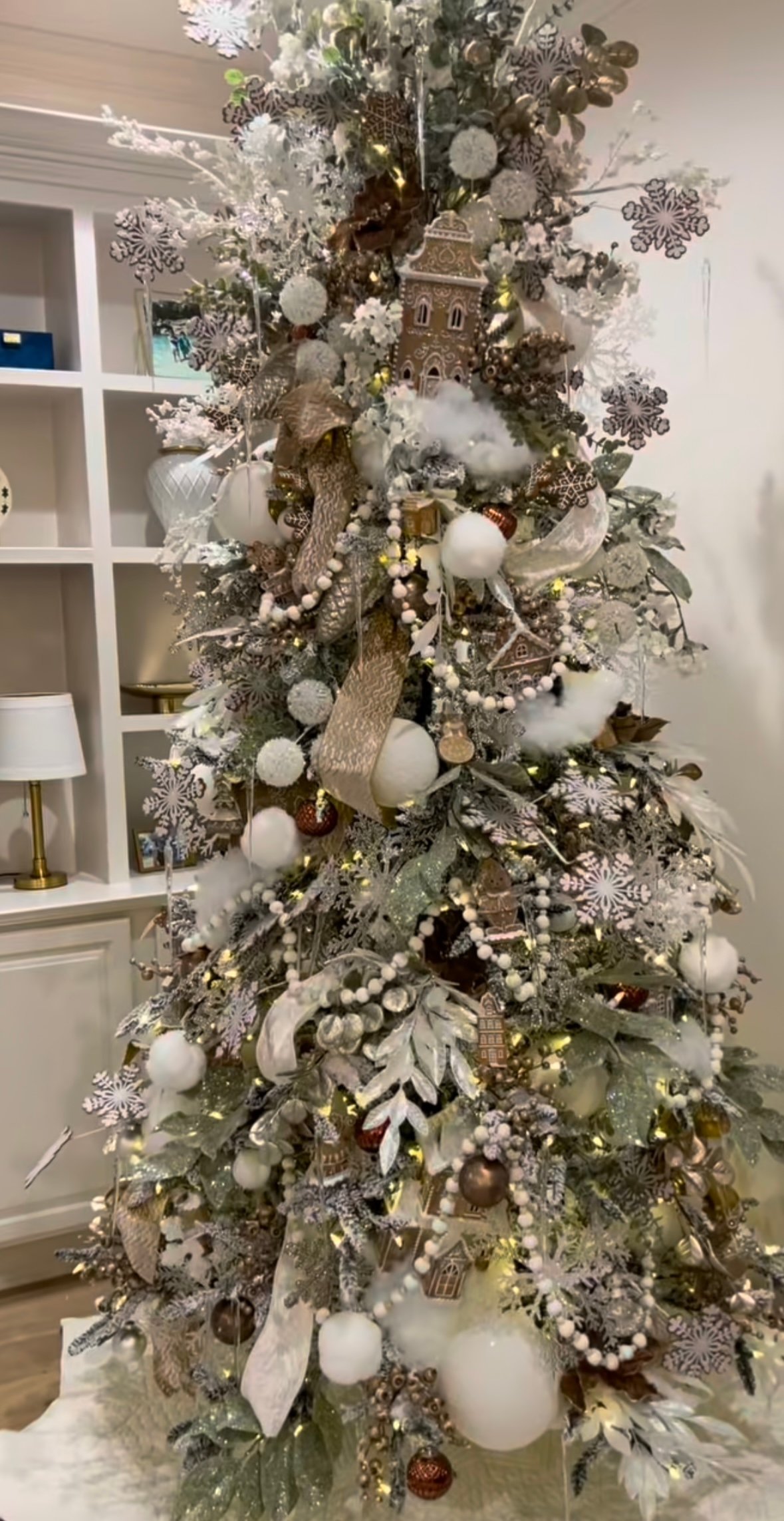 Warm white and brown gingerbread Christmas tree with snowflake ornaments, pom-pom garlands, and cookie-inspired accents.