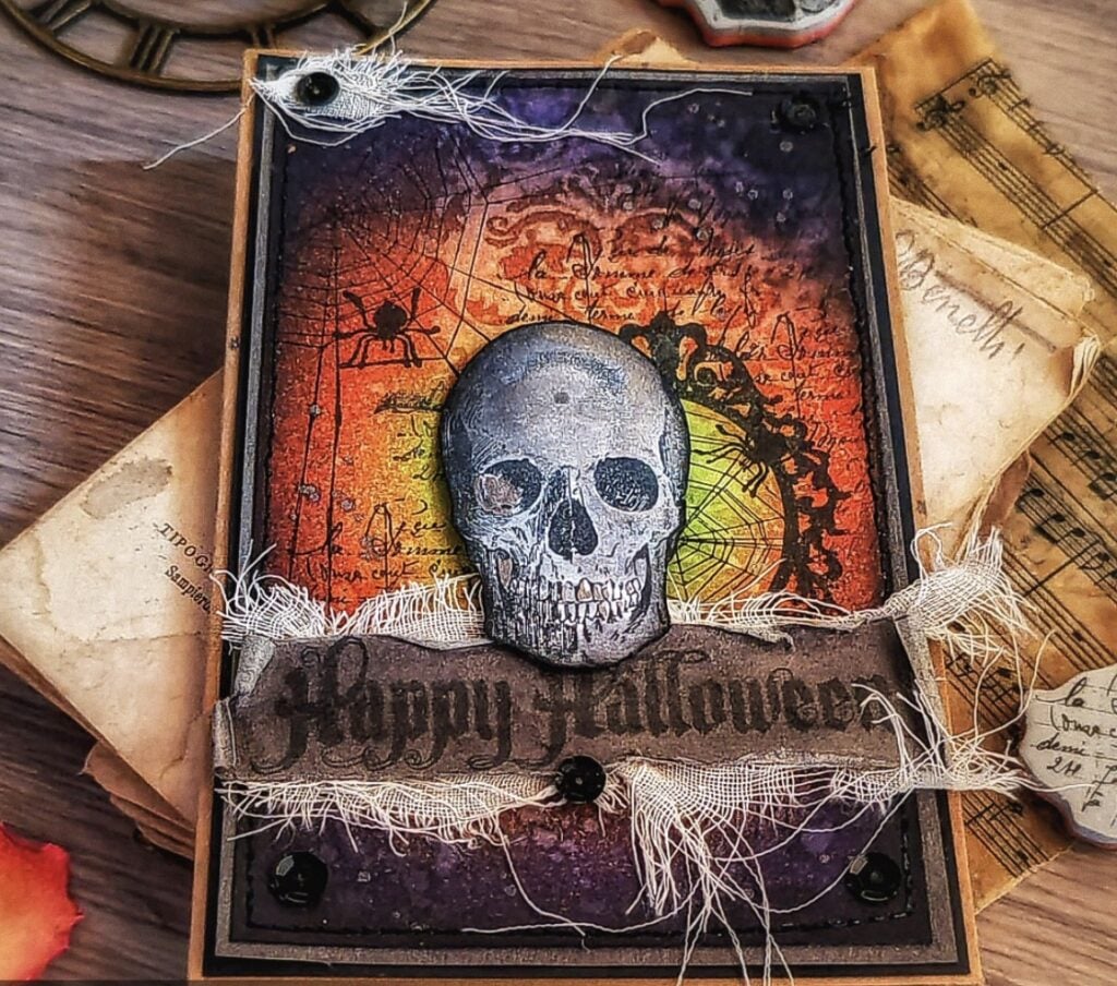 Gothic skull panel with stamped bones, label ephemera, and inky vignette