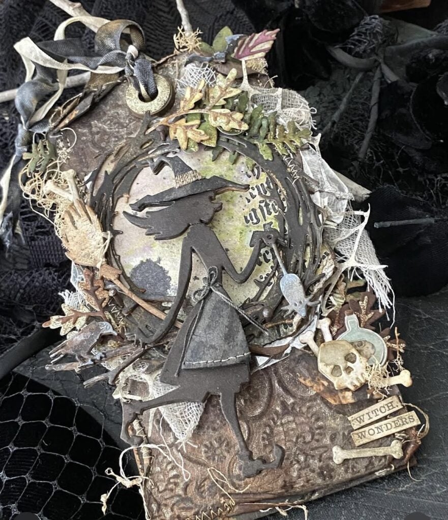 Cluster of Halloween tags with witch art, postage stamps, and vintage collage bits.