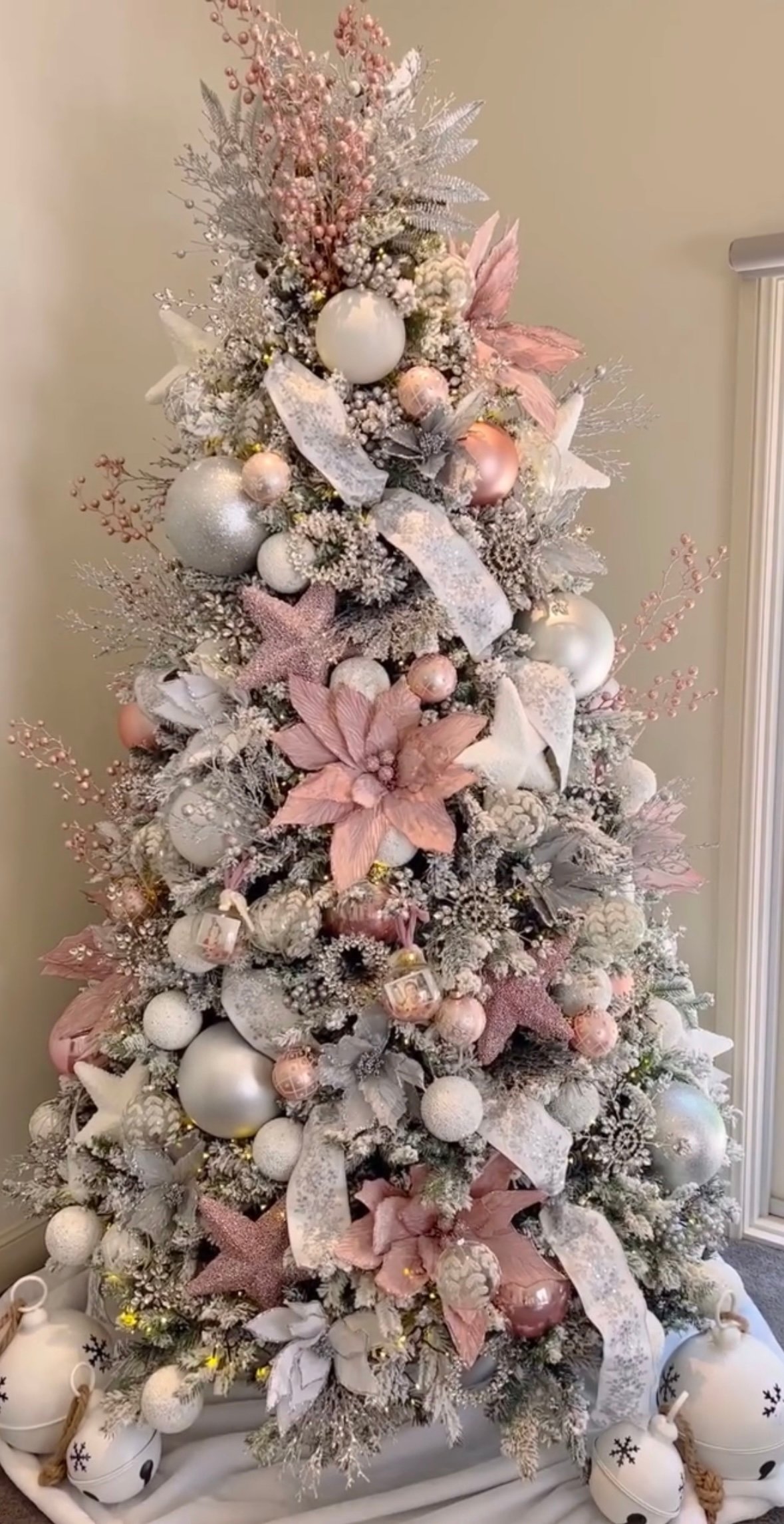 Blush pink and silver winter wonderland flocked tree with layered ribbons and soft pastel ornaments.