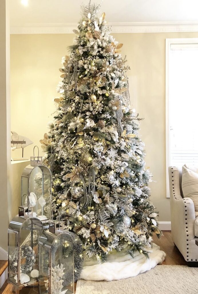Gold-and-silver winter wonderland tree with lanterns, glitter florals, and mercury-glass ornaments.