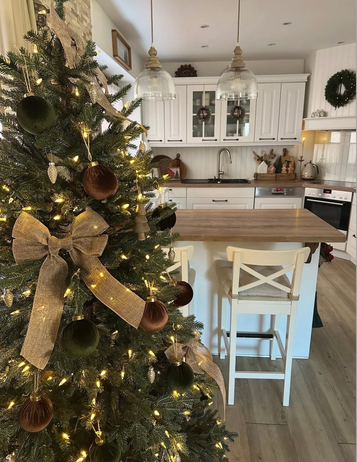 Brown Christmas tree decorated with warm neutral ornaments in a cozy holiday kitchen