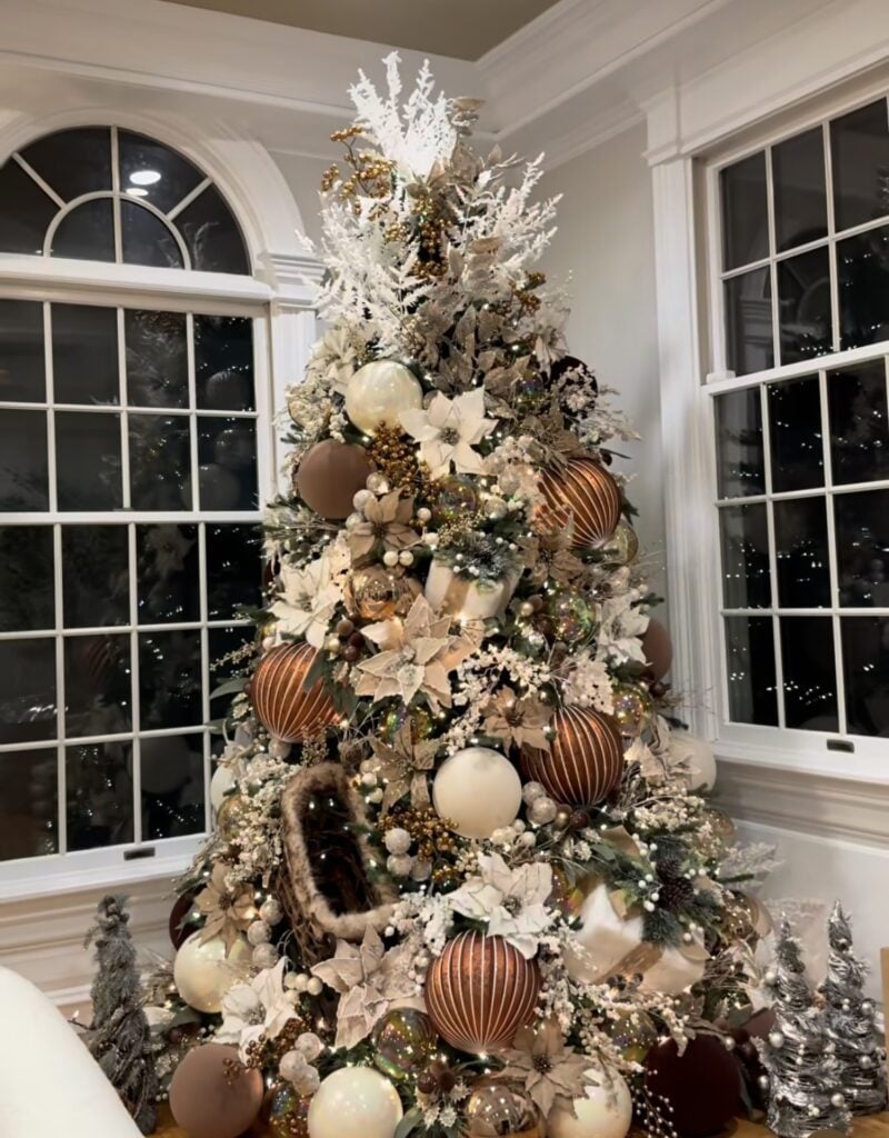 Brown Christmas tree with layered ornaments, rich neutral tones, and elegant festive decorations
