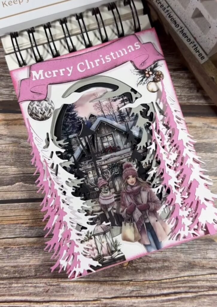 Pink Christmas scrapbook page with layered paper and festive embellishments