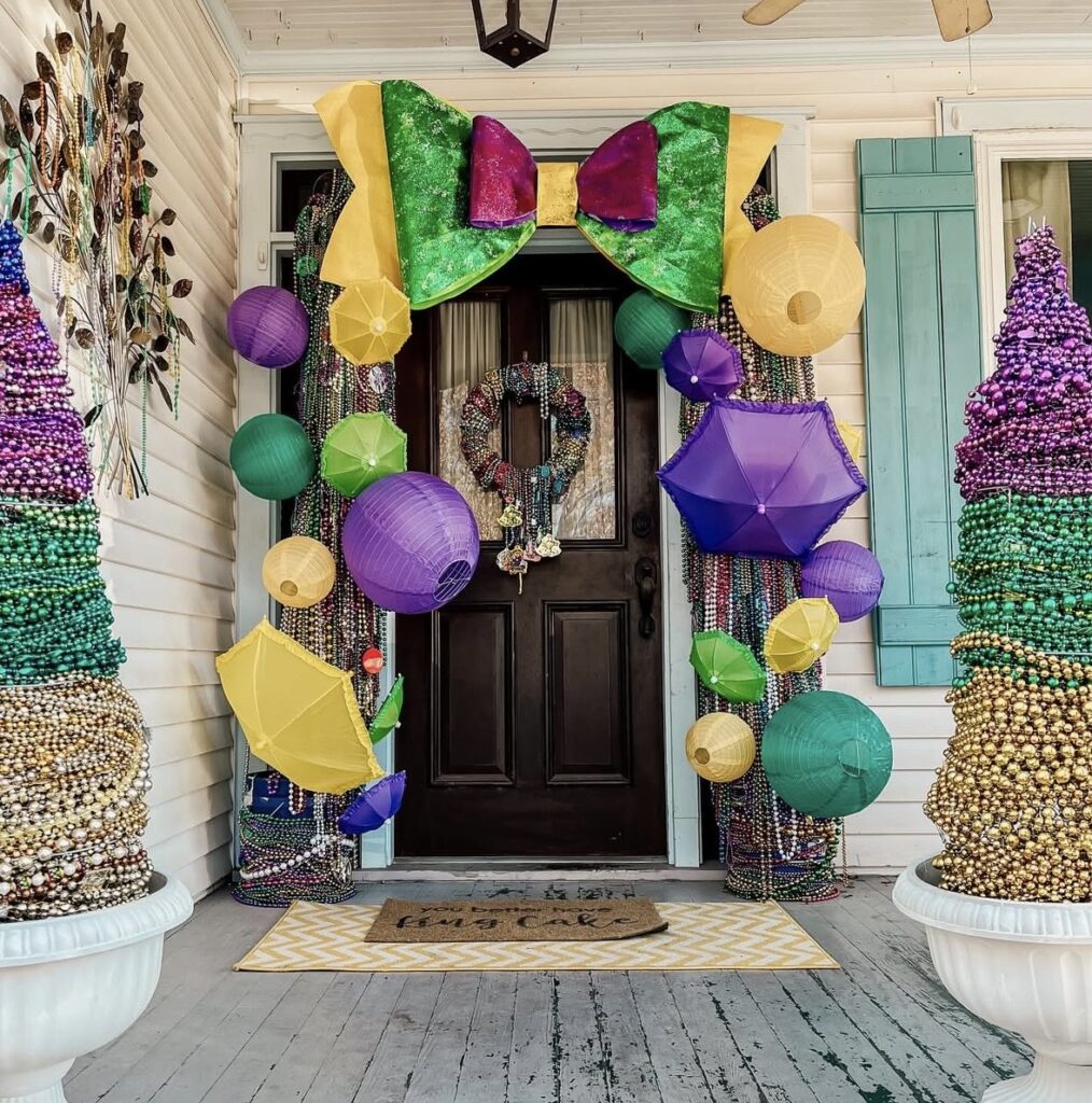 Mardi Gras porch decor featuring bold purple, green, and gold styling on the front entry.