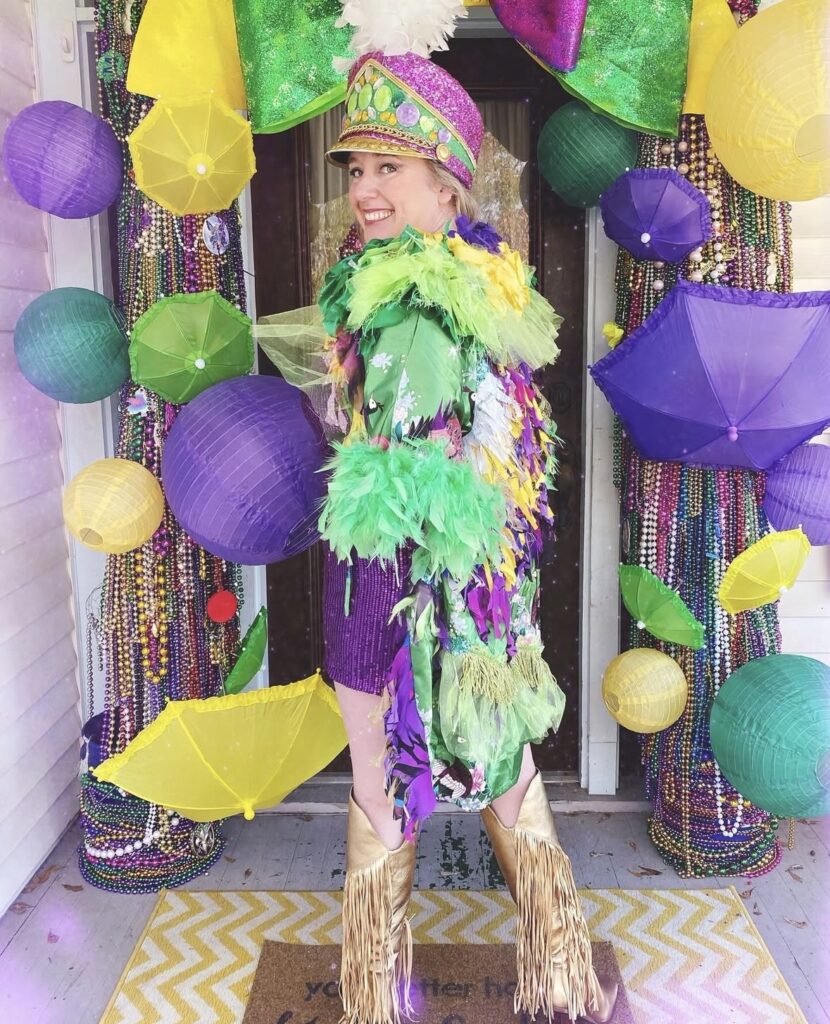 Katy from The Porch Club wearing a Mardi Gras outfit in purple, green, and gold.