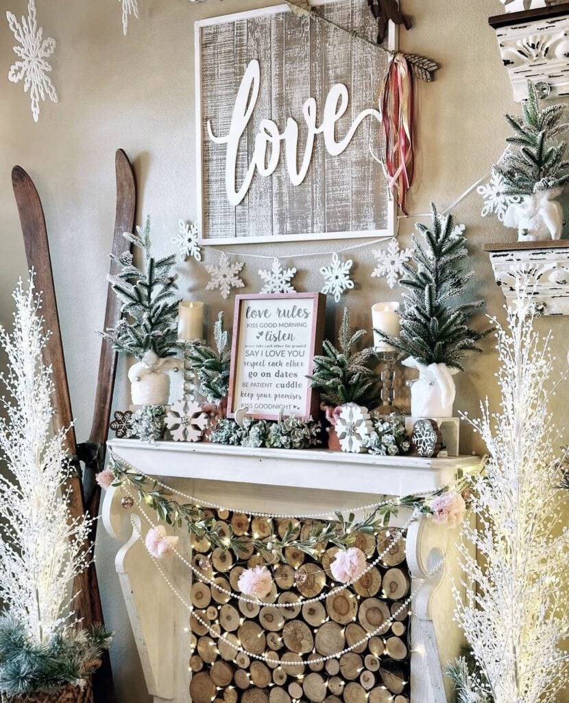 neutral winter and valentine mantle decor with wood, snowflakes and hearts and sign with love over it