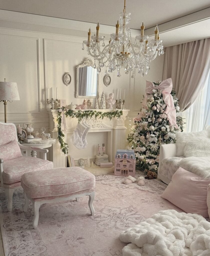 Elegant green Christmas tree decorated with a large blush bow, pink and white ornaments, and delicate ribbons in a soft pink and white living room.