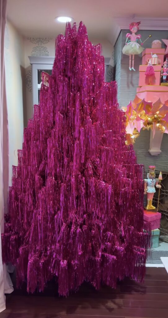 Pink tinsel Christmas tree with playful decorations and colorful holiday inspiration
