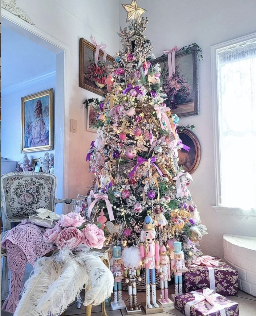 Vintage-inspired pink Christmas tree display decorated in soft blush tones with romantic holiday accents and feminine details.