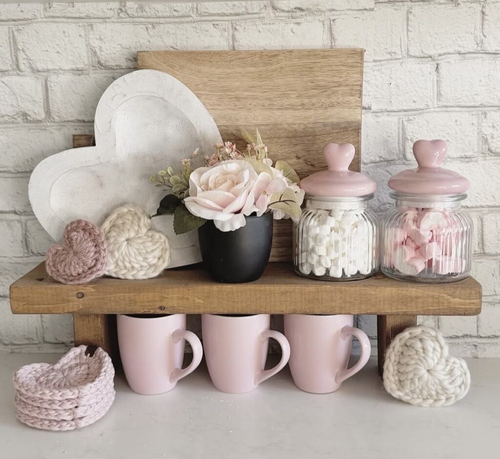 Pink Valentine’s Day decor display with blush accents, cozy styling, and heart-themed details