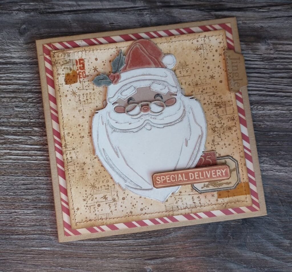 vintage Santa scrapbook cover with layered Christmas papers, ephemera, holly and distressed edges