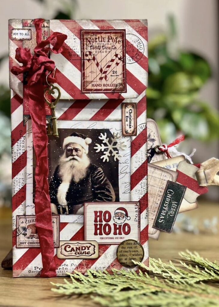 Santa junk journal page with mixed media background, Christmas music paper, holly and layered embellishments