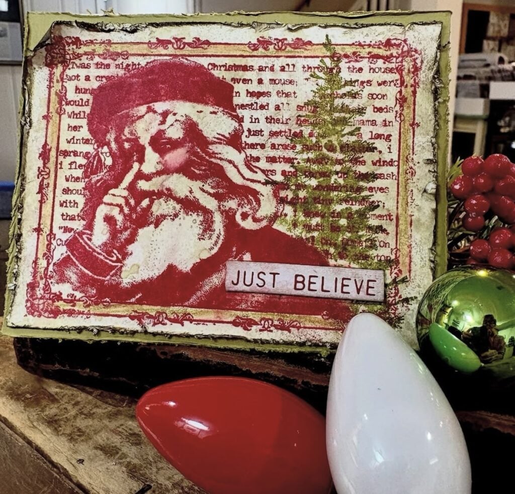 Vintage Santa mixed media Christmas page with red stamped image, tree background and Just Believe sentiment