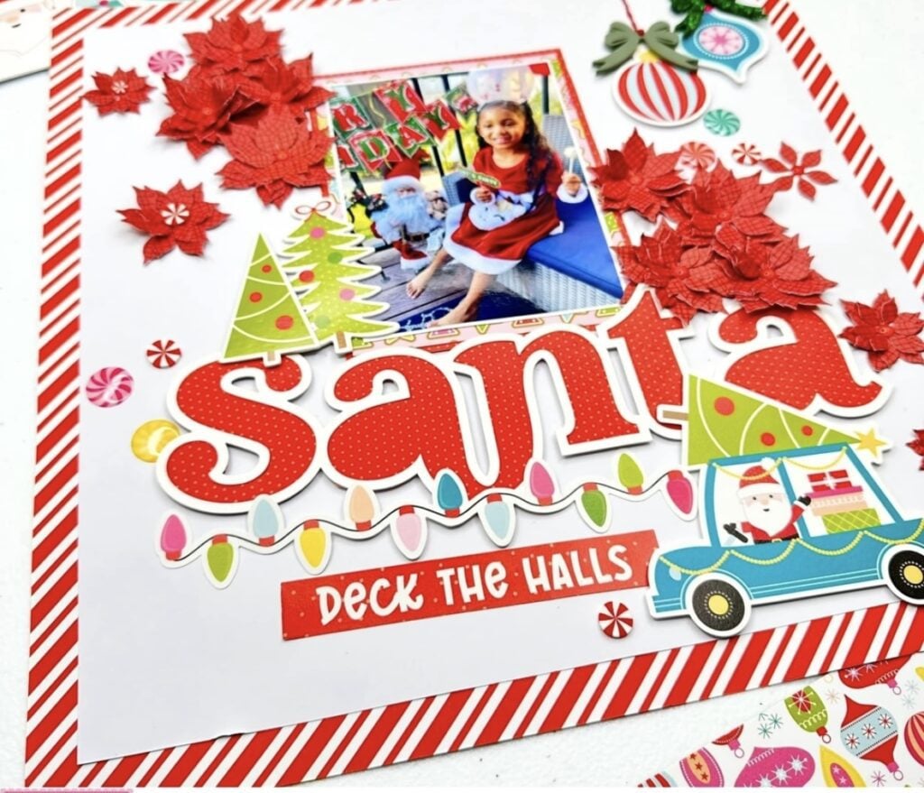 Santa scrapbook page with photo, bright Christmas colors, poinsettias and playful holiday embellishments