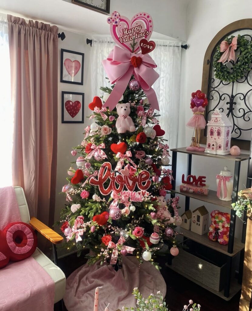 Valentines Day tree with layered pink and red decorations next to a comfy seating area, credit allthingscute_and_coffee.
