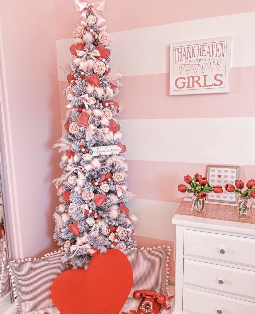 Valentines Day tree styled with oversized bows, heart ornaments, and layered ribbon, credit just_addabow.