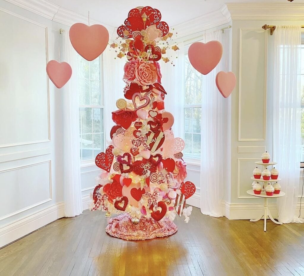 Valentines Day tree with blush and red decor placed in a grand, historic style room, credit making_over_a_mansion.