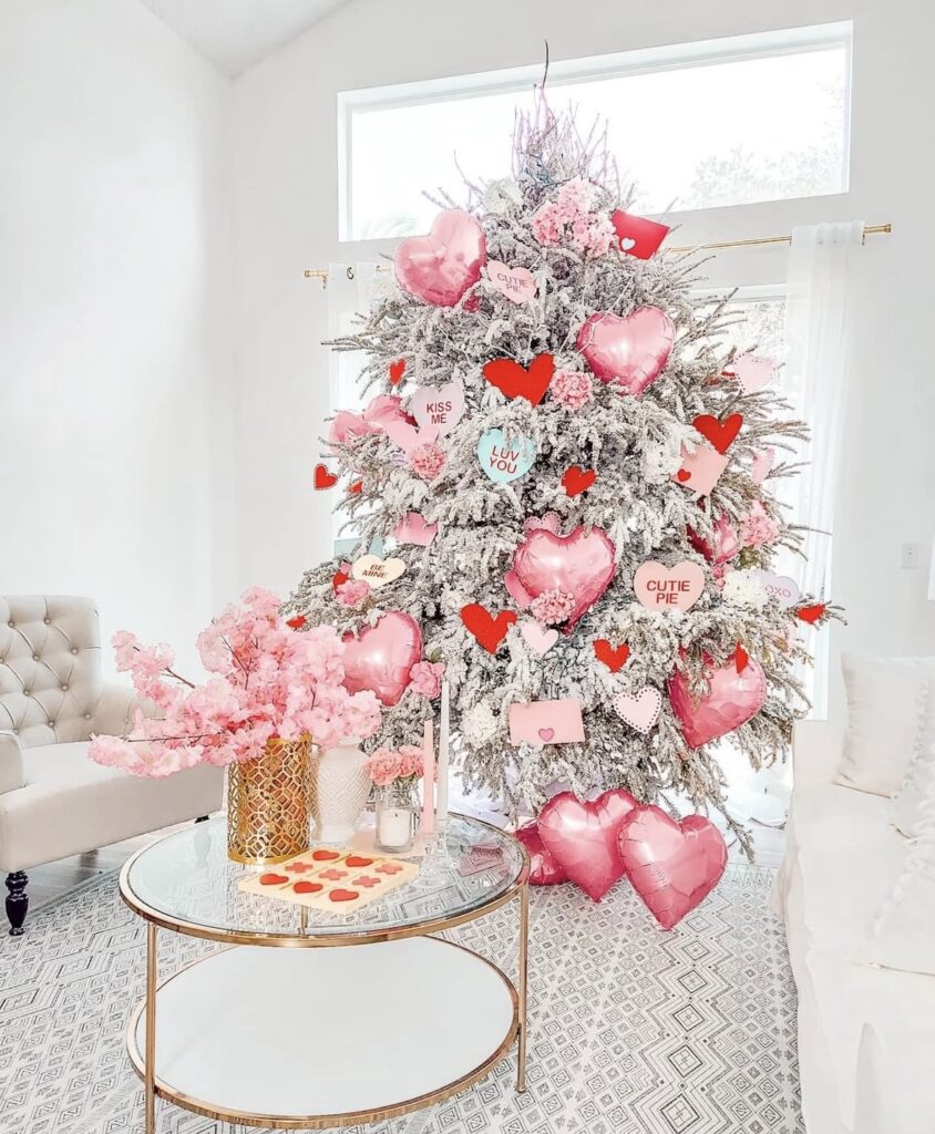 Elegant Valentines Day tree with soft pink ornaments, floral picks, and warm white lights, credit theluxmylife.