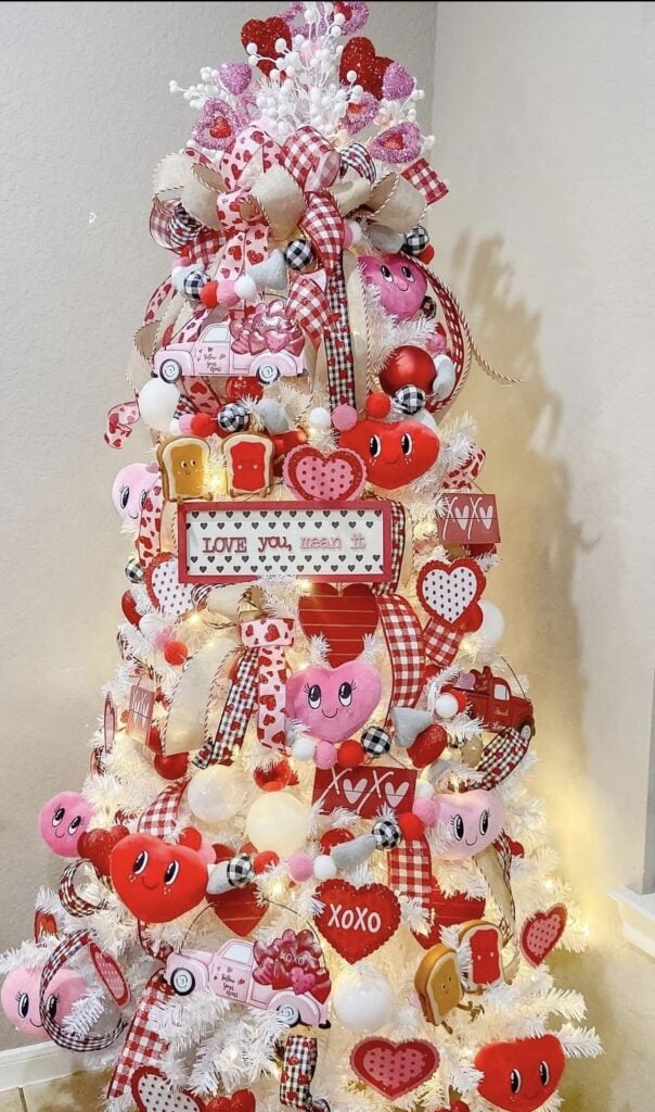 Valentines Day tree with red checked ribbon, red and pink stuffed animal hearts, and valentines signs, credit the_frugalfarmhouse.