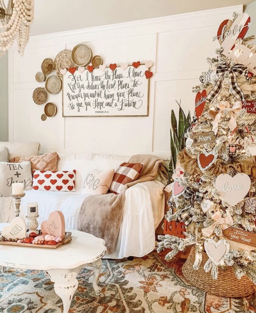 Full Valentines Day tree layered with pink and red ornaments, heart garlands, and ribbon, credit fancyfixdecor.