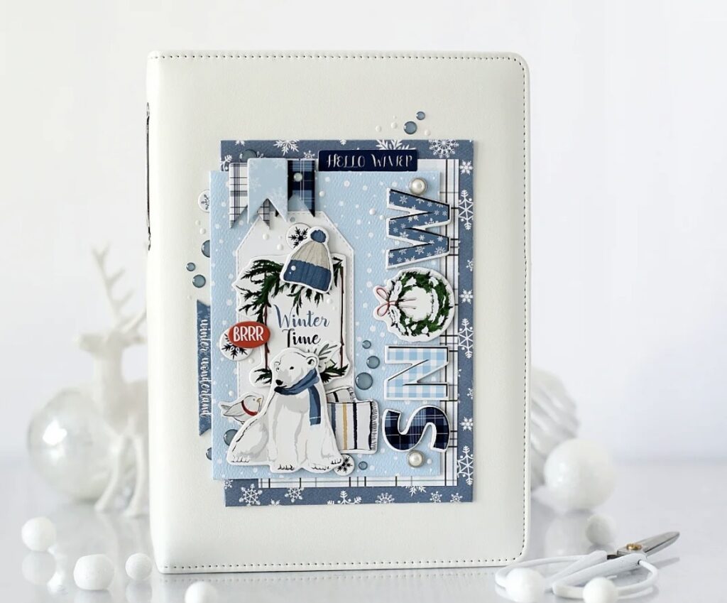 Winter scrapbook cover page with a clean winter theme design, layered details, and seasonal title styling with polar bear, snow skies.