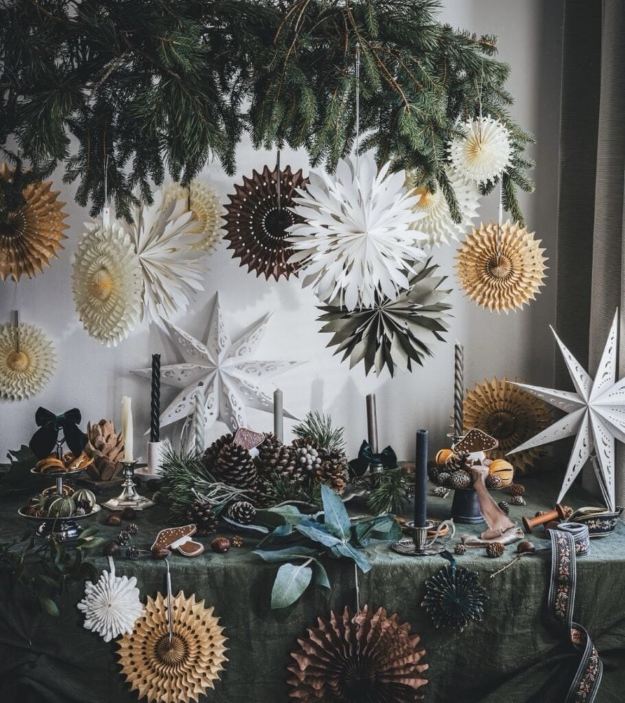 Nature-inspired Yule altar decorated with evergreen, candles, dried citrus, pine cones, stars, and woodland accents for the Winter Solstice.