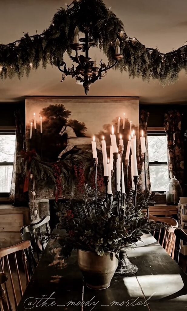 Cozy woodland-inspired Winter Solstice display featuring candles, evergreen branches, pine cones, and earthy natural textures.