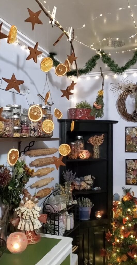 Neutral Winter Solstice decorating with star garland and dried orange garland holiday decor