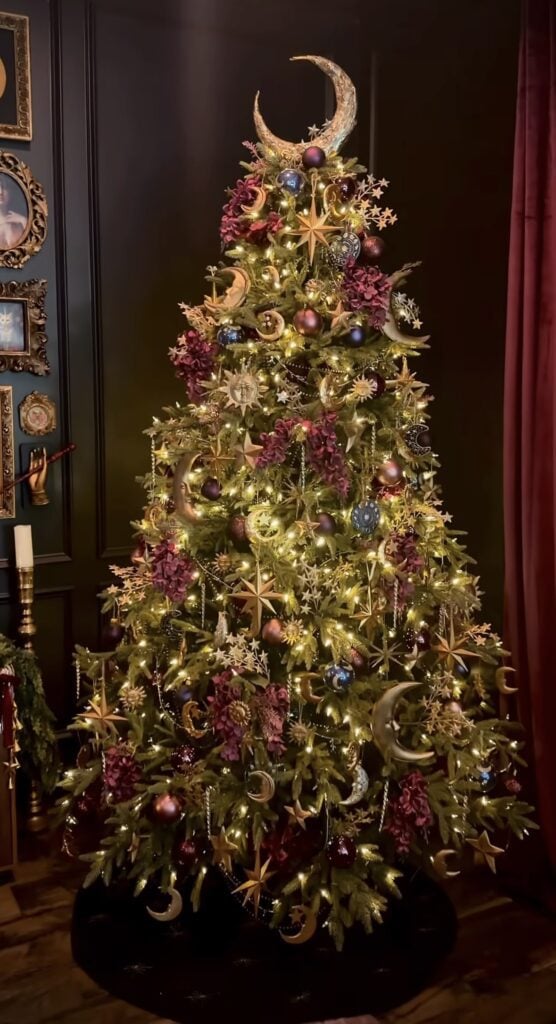 Celestial inspired Yule tree decorated with moon, stars and a quarter moon topper