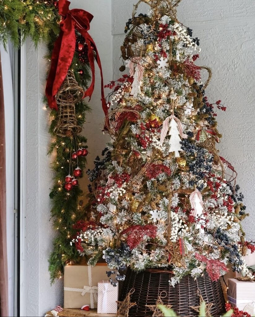 Neutral Winter Solstice tree with red accents, natural textures, wooden ornaments and home made ornaments, greenery, and simple Scandinavian-inspired holiday decor.
