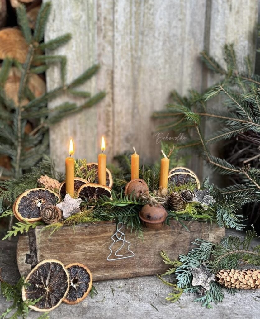 Rustic Yule decorating with candles, stars, evergreen garlands, natural wood accents, and cozy Winter Solstice styling.