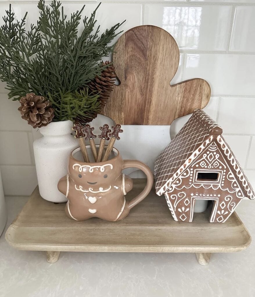 Gingerbread kitchen riser styled with a gingerbread mug, house-shaped cookie jar, and festive Christmas accents, featured by slowestuff.com.