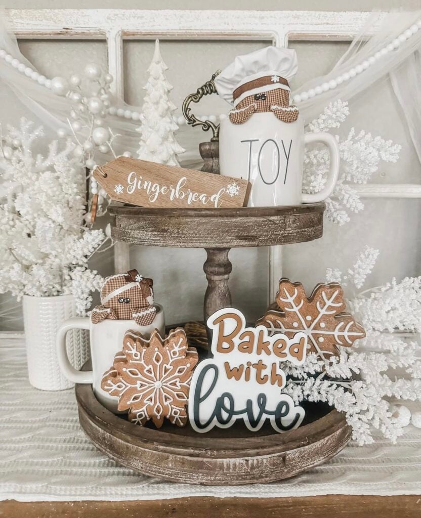 Neutral gingerbread tiered tray decorated with cream canisters, wooden bead garland, and soft brown and white gingerbread accents.