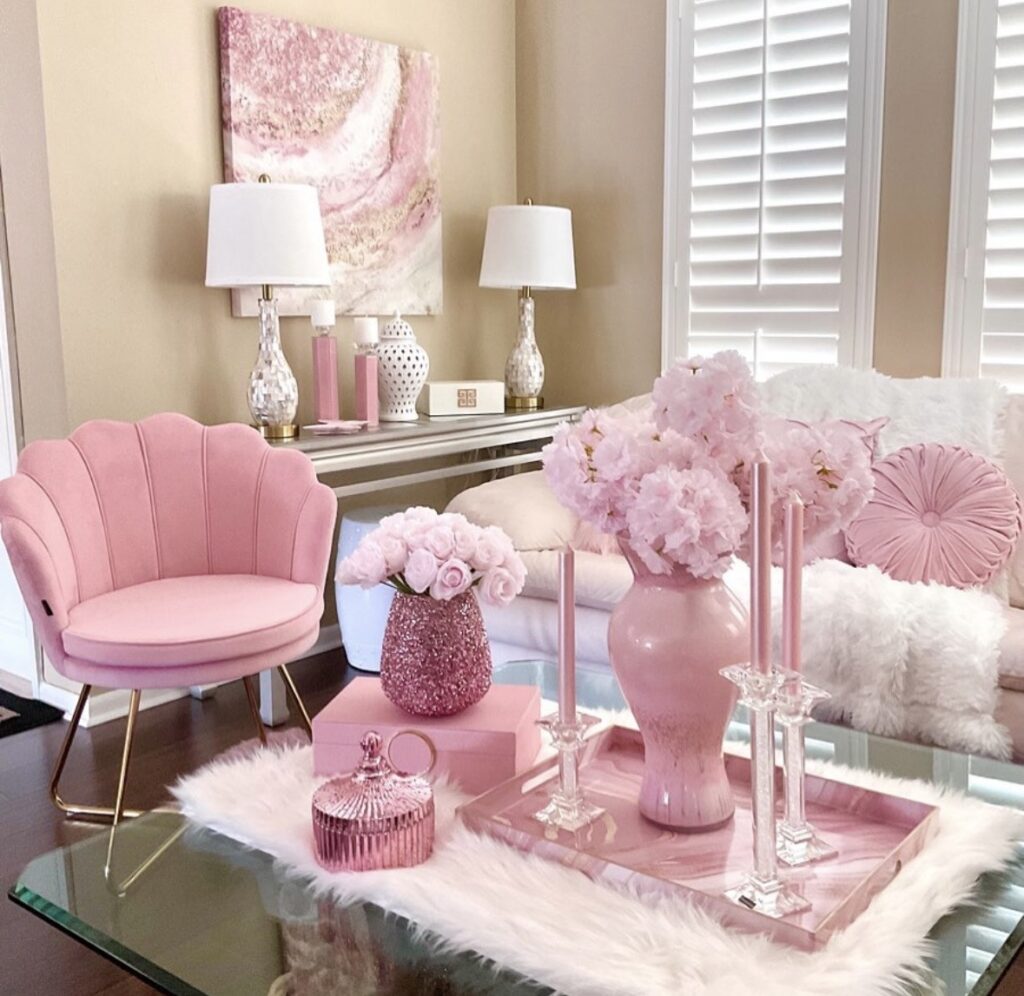 Light pink Valentine’s Day living room decor with blush shell chair, pink hydrangeas, taper candles, and a pink coffee table tray.