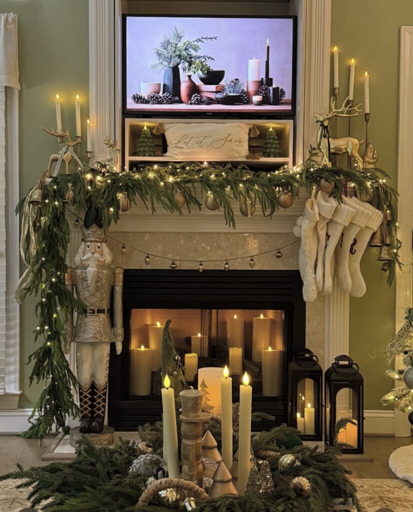 Neutral Christmas fireplace mantel decorated with evergreen garland, stockings, candles, and a nutcracker for a cozy holiday look, featured by slowestuff.com.