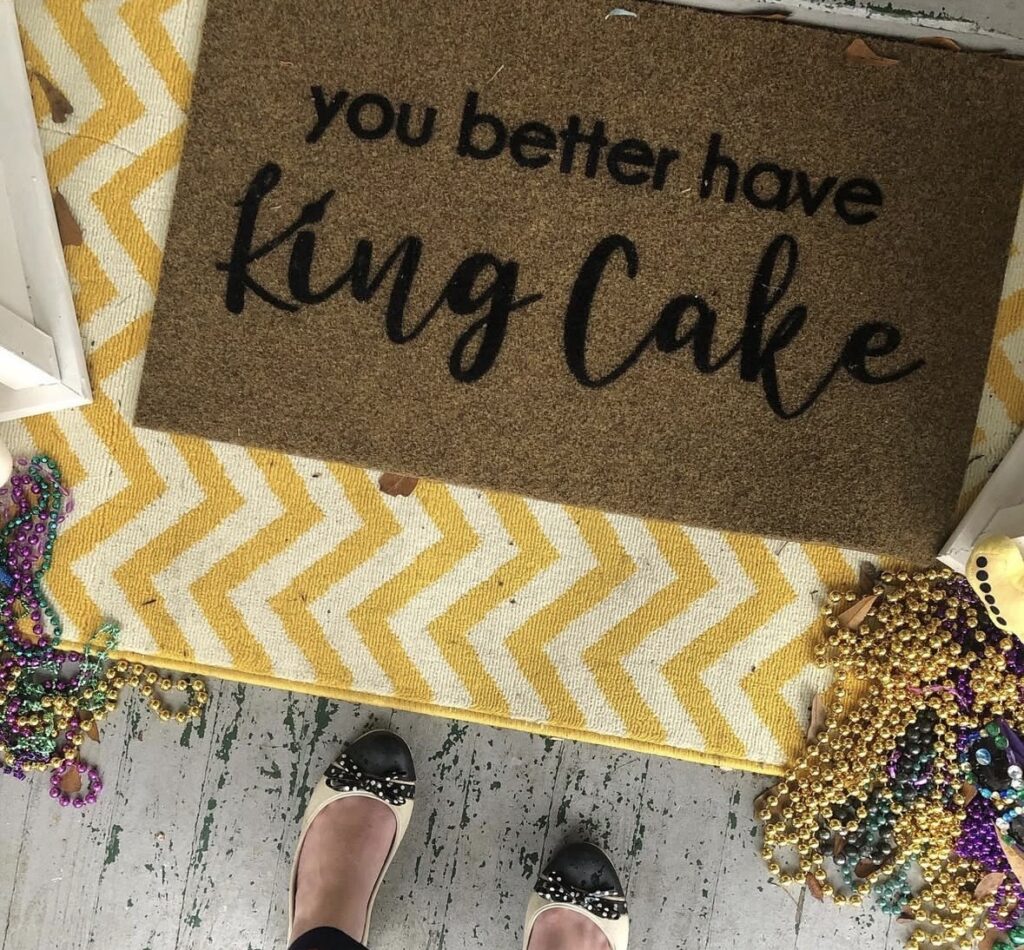 Neutral Mardi Gras doormat with seasonal wording and muted tones that pair well with bright Mardi Gras decor.