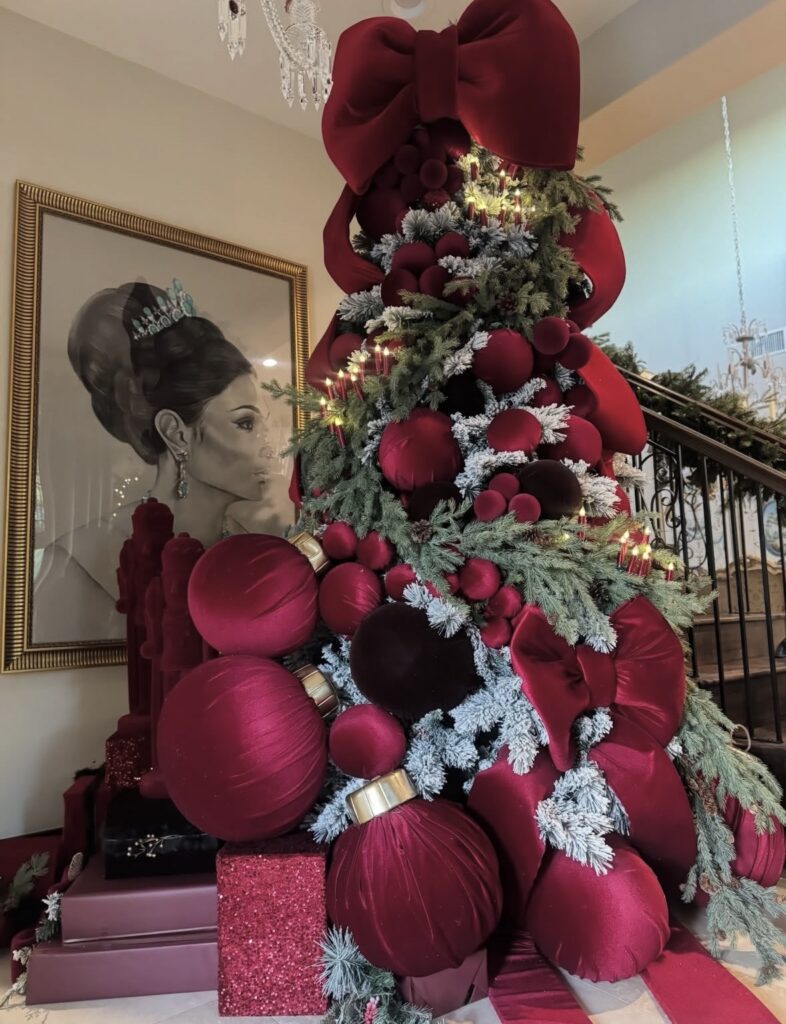 Non-traditional Christmas tree with floral accents and dramatic festive decorations
