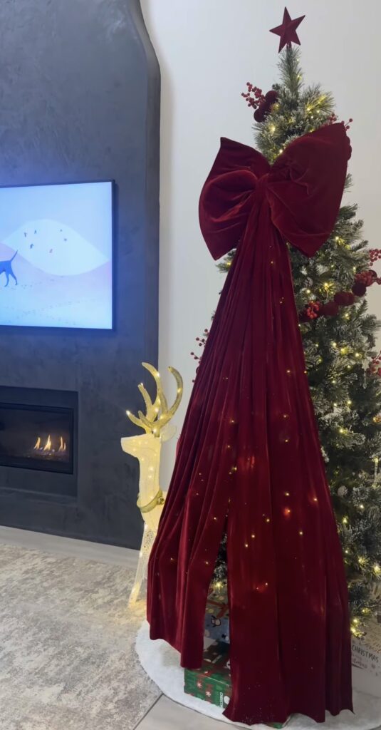 Non-traditional Christmas tree with giant bow with colorful decorations and creative seasonal style